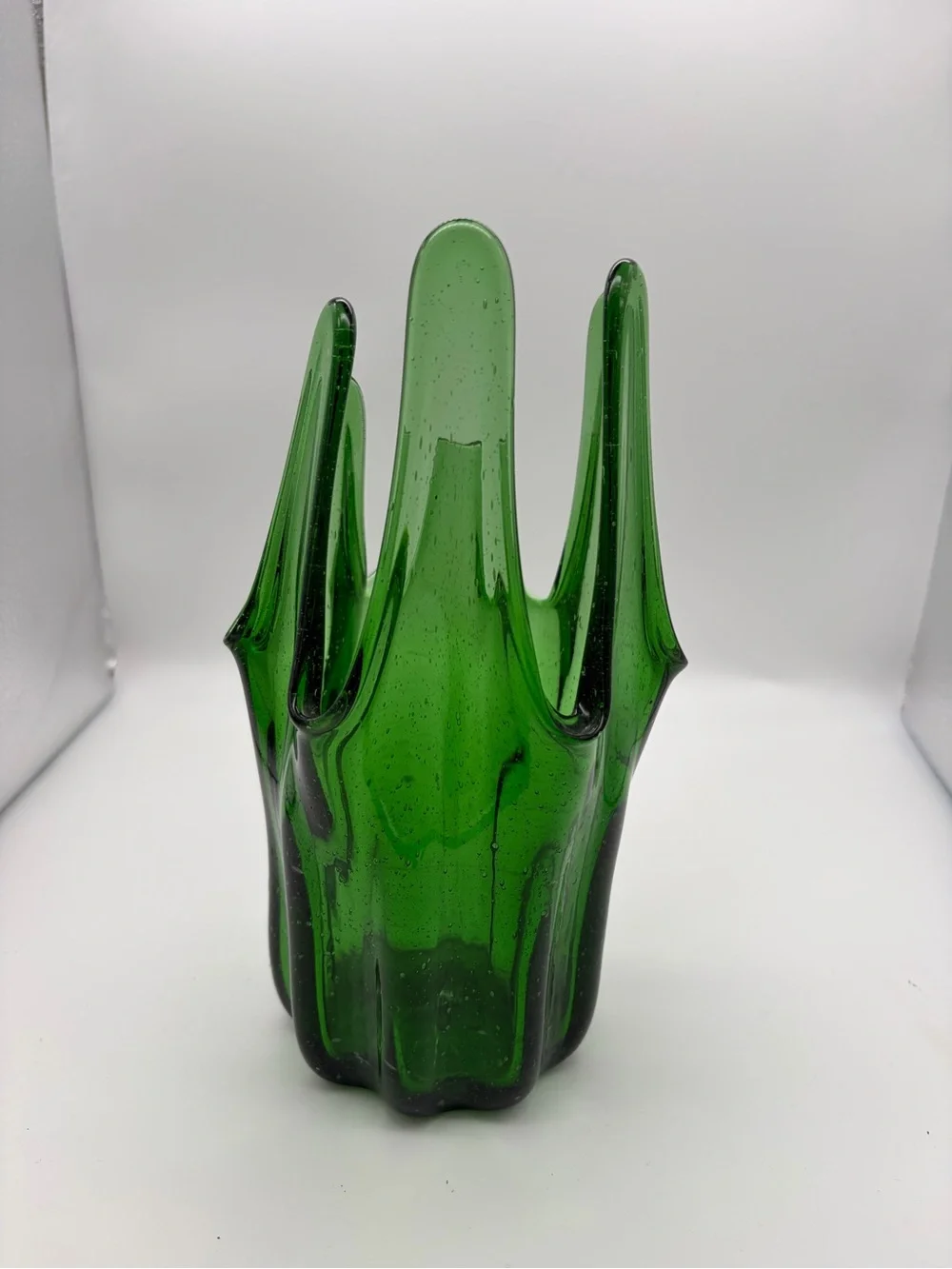 Vintage green swing glass vase with purple lily trumpet flowers.
